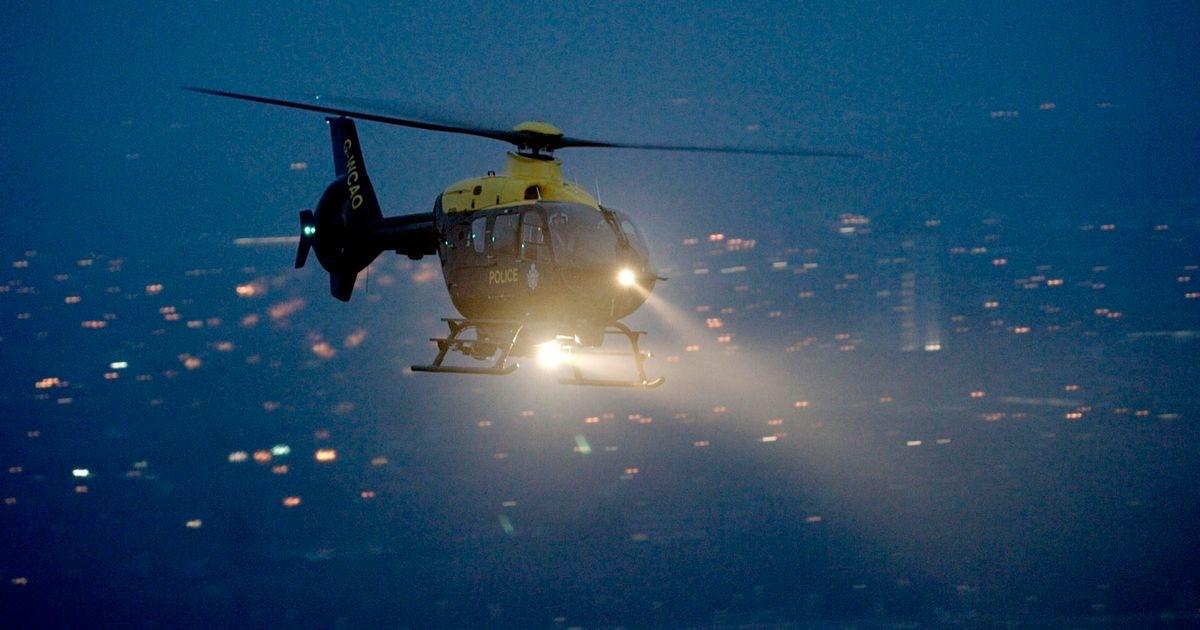 NPAS helicopter flying at night with NightSun light illuminated