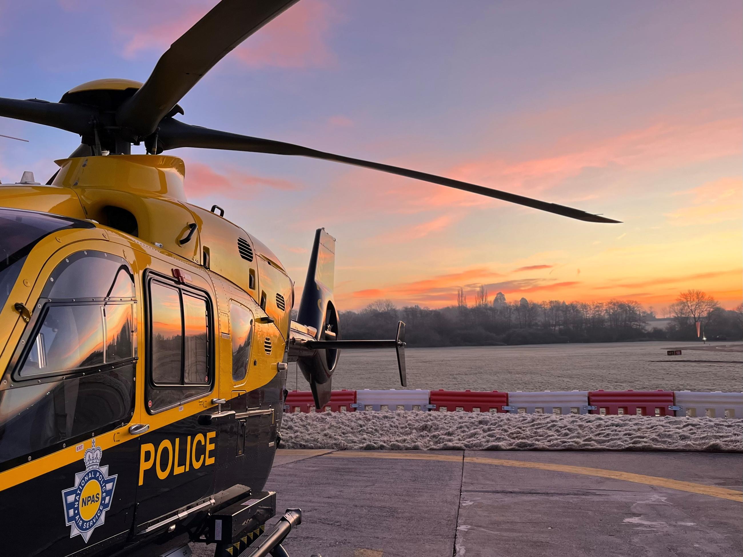 Photo of police helicopter at sunrise