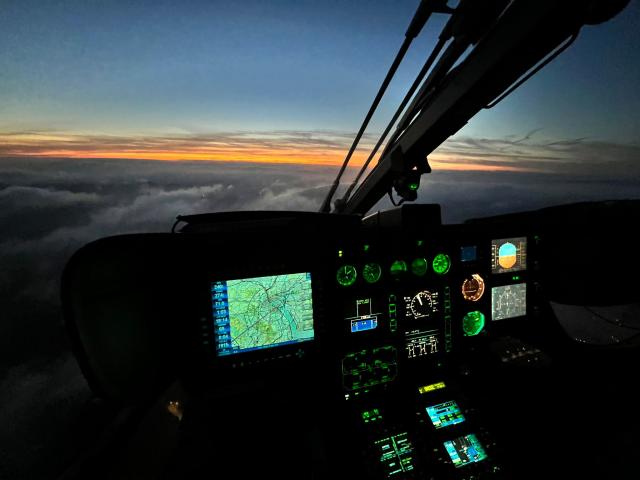 Inside a helicopter cab whilst in flight at night